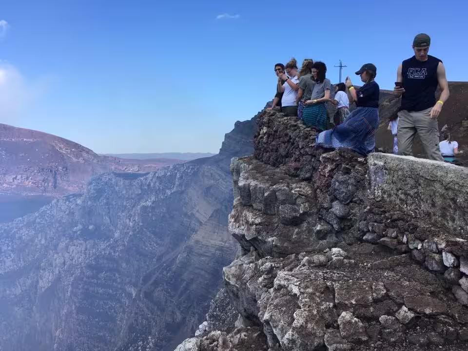 Travelers observing the active smoking crater at Masaya Volcano National Park in Nicaragua